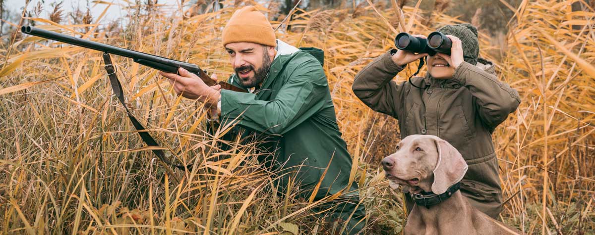 Two hunters and their hunting dog