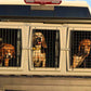 Easy Loader Three Hole Kennel with three hunting dogs loaded into a pickup truck bed.